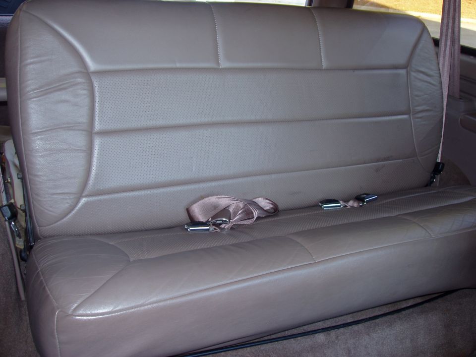 Tan leather rear bench seat with seatbelts