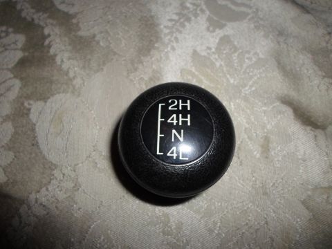 1990 Ford Bronco - Transfer case shifter knob displays 2H, 4H, N, and 4L settings.