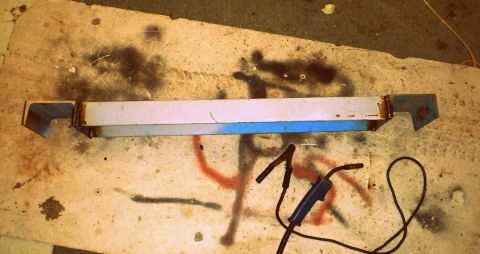 1964 Mercury Monterey - Welding leads and a metal bar are shown on a workbench with spray paint markings.