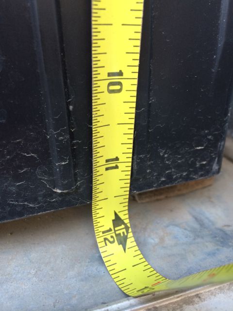 1986 Yugo GV - Measuring tape against a black plastic container, showing measurements from 10 to 12 inches.