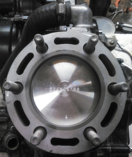 Engine cylinder with piston showing part number 526M067.00