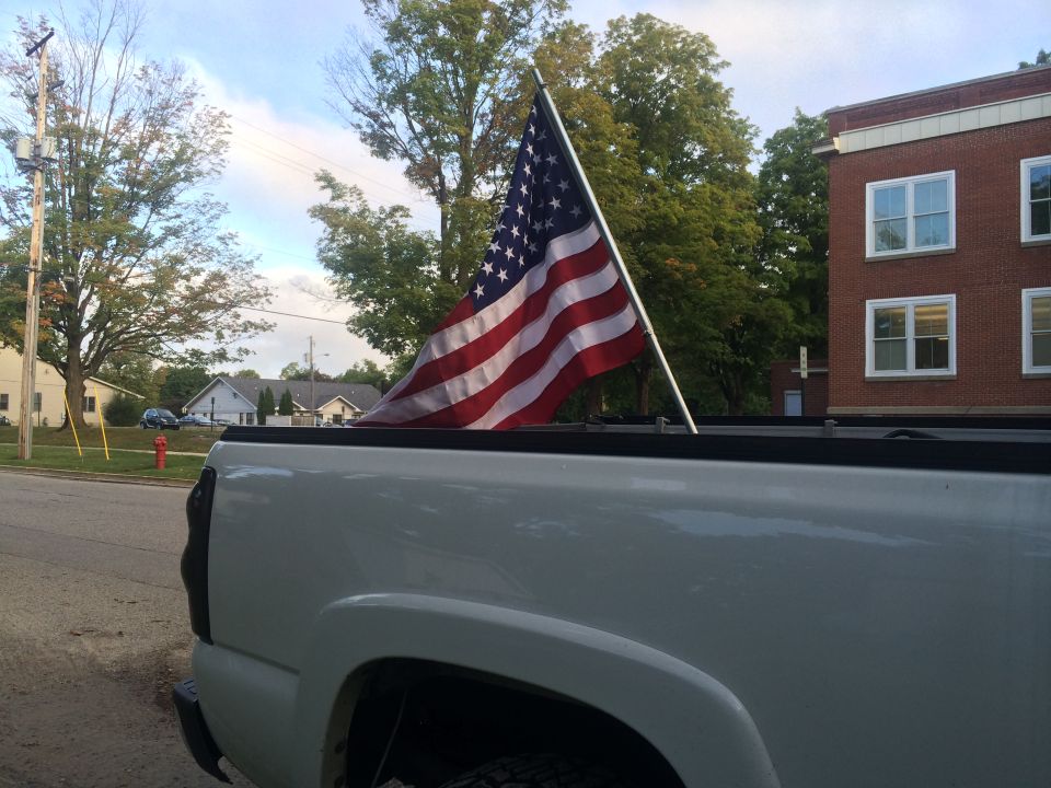 White 2006 Chevrolet Silverado 2500 rear quarter panel with American flag