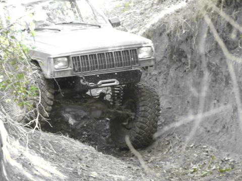 1995 Ford Bronco - This modified Jeep Cherokee navigates a challenging off-road trail, its capabilities.