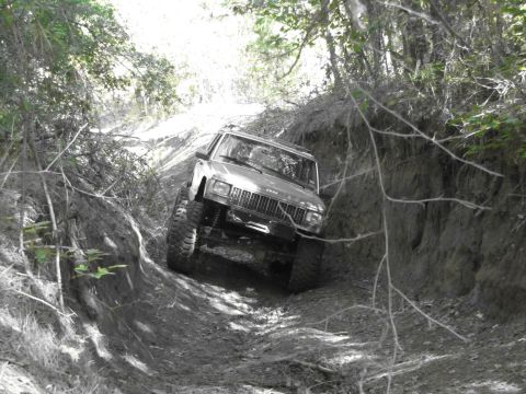 1995 Ford Bronco - A Jeep Cherokee XJ navigates a challenging off-road trail, its capabilities.
