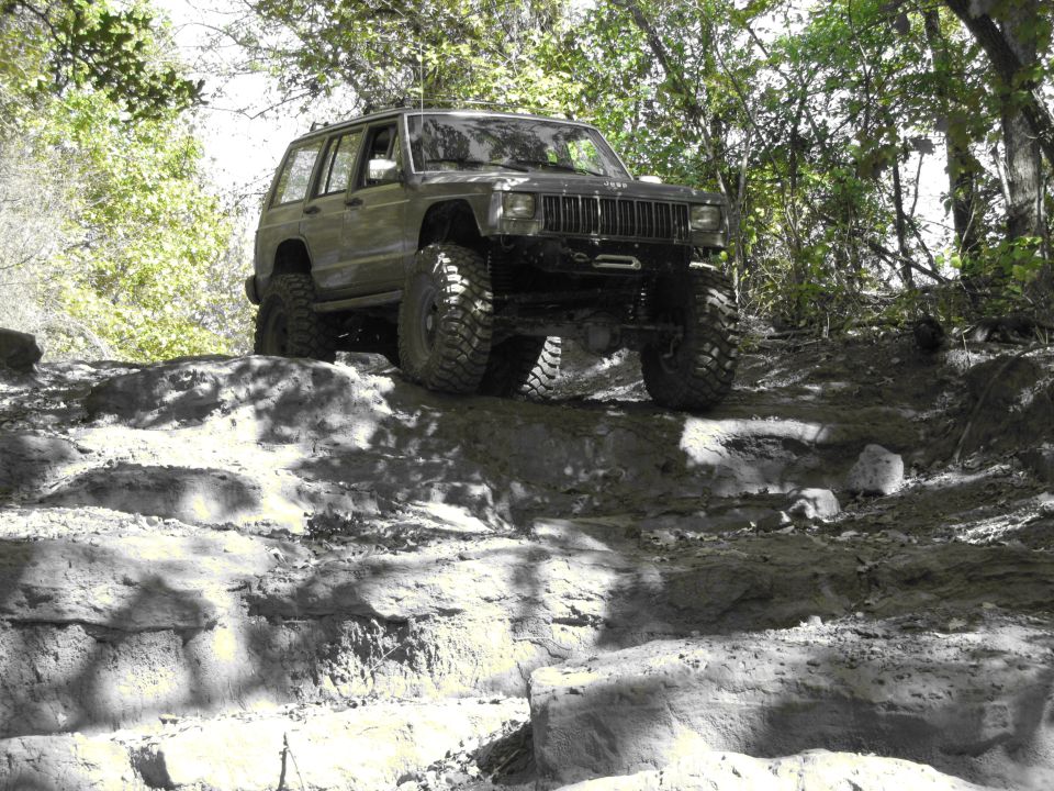 Jeep Cherokee XJ climbing a rocky hill