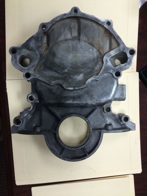 1996 Ford Bronco - This is a metal engine timing cover, likely for a Ford vehicle, with visible part numbers.