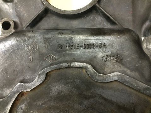 1996 Ford Bronco - Close-up of a Ford timing cover with part number RF-E7TE-6059-BA and the Ford logo visible.
