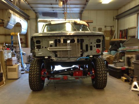 1993 Ford Bronco - Front view of a 1993 Ford Bronco undergoing restoration in a workshop.