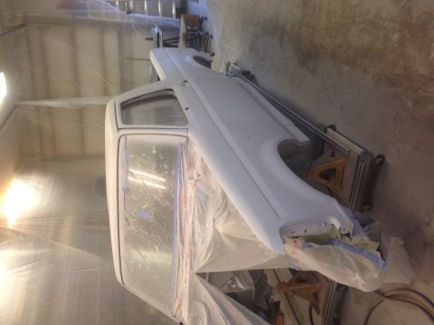1993 Ford Bronco - A white 1992 Ford Bronco is prepped for painting inside a booth.