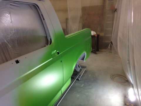 1993 Ford Bronco - A 1993 Ford Bronco is being painted a bright green in a spray booth.