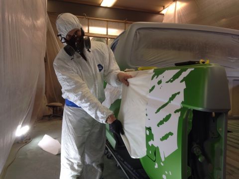 1993 Ford Bronco - Applying custom graphics to a vehicle in a paint booth.