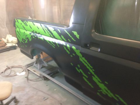 1993 Ford Bronco - This Ford Bronco, likely a 1992 model, is undergoing work with custom green graphics on its side.
