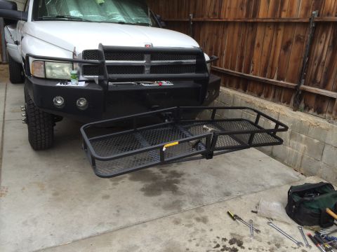 1997 Dodge 3500 - A white Dodge pickup truck from the mid-1990s is shown with a front hitch rack, parked in a driveway.