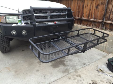 1997 Dodge 3500 - A black hitch rack is mounted to the front bumper of a white 1997 Dodge 3500 pickup truck.