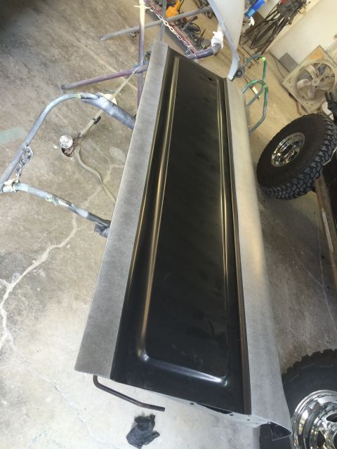 1989 Ford Bronco - Tailgate undergoing preparation for painting in a workshop setting.