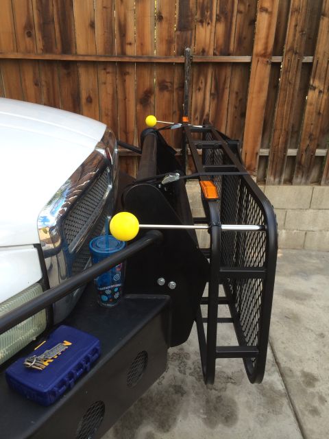 1997 Dodge 3500 - Front bumper rack with yellow guide balls and a blue cup attached to the side.