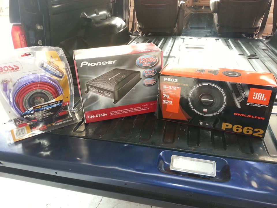 Photo of car audio product boxes on a tailgate