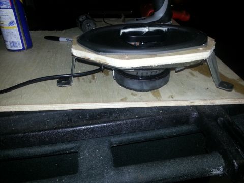 1994 Ford Bronco - Photograph of a car speaker mounted to a plywood baffle on a workbench, not a technical document.