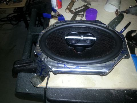 1994 Ford Bronco - Photograph of a car speaker taped into a plywood mounting baffle, not a technical document.
