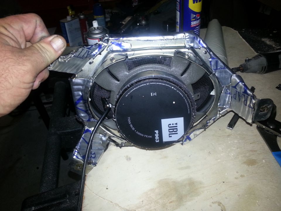 Photo of a hand holding a JBL P963 speaker assembly