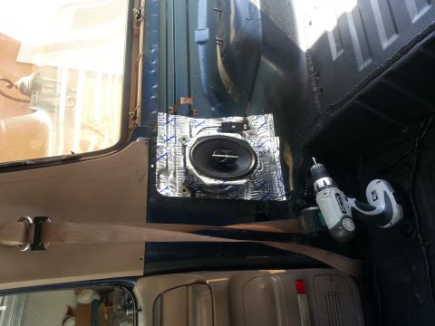 1994 Ford Bronco - Photograph of a car speaker installed with sound-deadening material inside a vehicle, not a document.