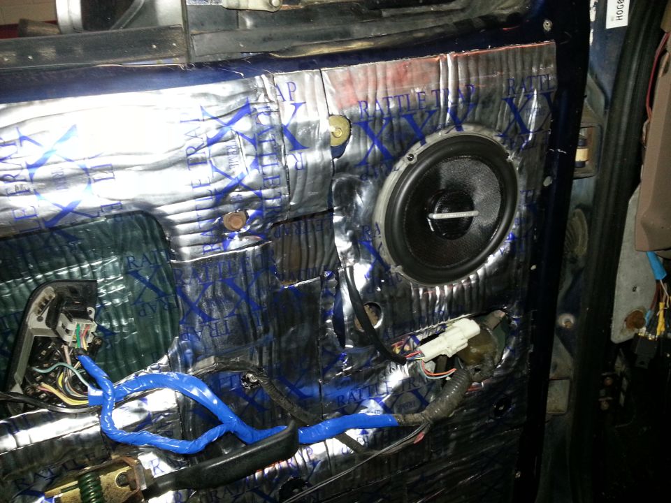 Photo of a car door with sound deadening, speaker and wiring