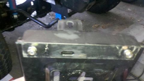 1982 Ford Bronco - A close-up view shows the underside of a vehicle, focusing on a black metal component with two visible bolts and a rectangular slot. The co…