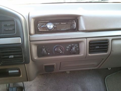 1994 Ford Bronco - Photograph of a vehicle dashboard with an aftermarket Pioneer radio and climate controls, not a document.