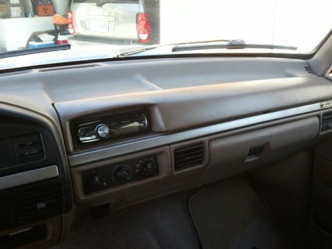 1994 Ford Bronco - Photograph of a vehicle dashboard with aftermarket radio and HVAC controls, not a technical document.