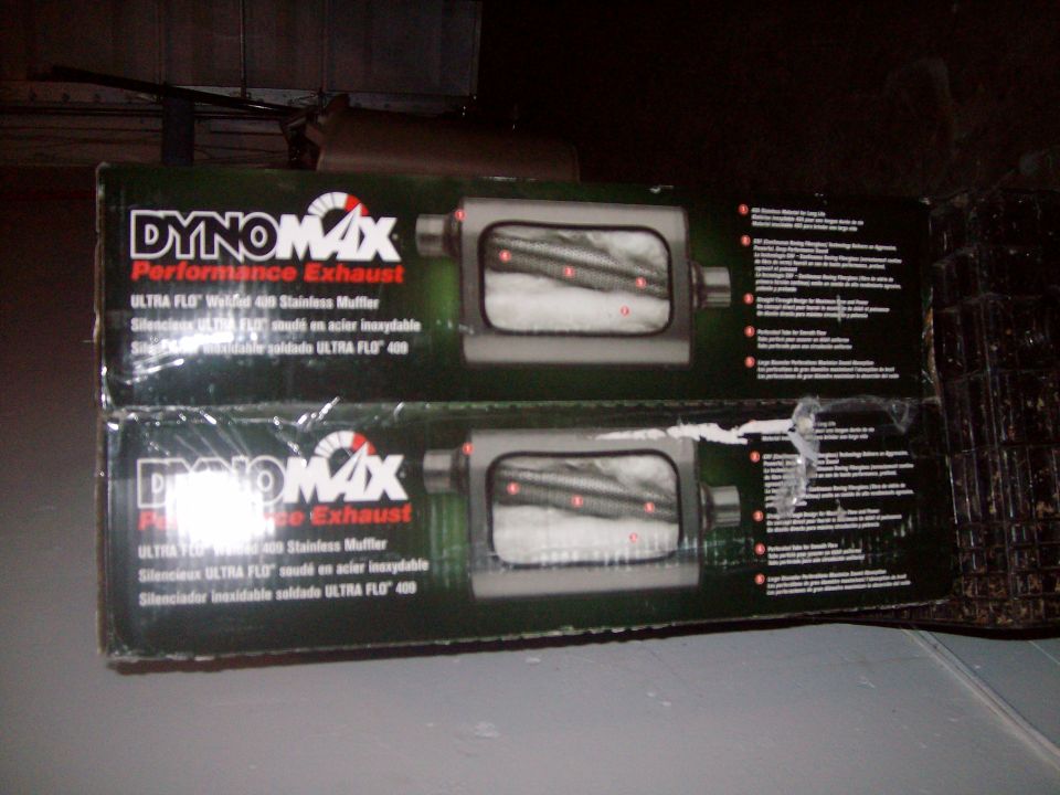 Two Dynomax Ultra Flo welded 409 stainless mufflers in original packaging