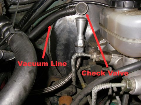1990 Ford Bronco - This image shows a close-up view of engine components, specifically a vacuum line and a check valve, likely from a 1990 Ford Bronco.