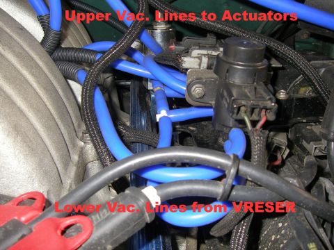 1990 Ford Bronco - Close-up view of blue vacuum lines connected to engine components in a 1990 Ford Bronco. The lines are labeled as "Upper Vac. Lines to Actu…
