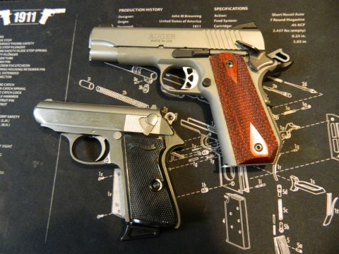 1979 Ford Bronco - Two handguns are displayed on a gun cleaning mat. The top handgun is a silver Ruger 1911 with red wood grips. The bottom handgun is a silve…