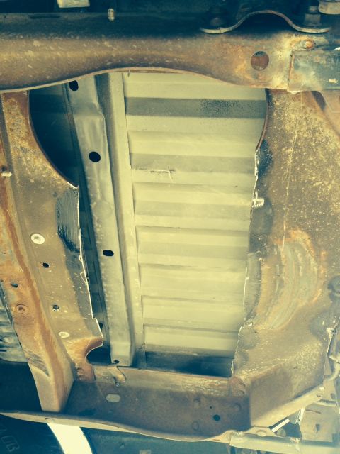 2001 Ford Ranger - The underside of a truck bed shows significant rust on the frame components.