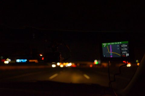 2003 Ford Taurus - Driving at night, the GPS screen displays navigation information including the upcoming exit and distance.