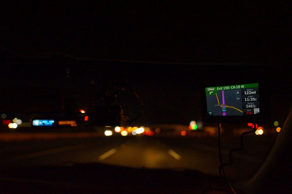 Interior view at night, GPS screen shows Exit 150: CA-18 W, 122mi remaining
