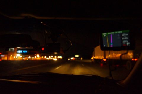 2003 Ford Taurus - Driving on the highway at night with traffic visible and a GPS navigation system active.