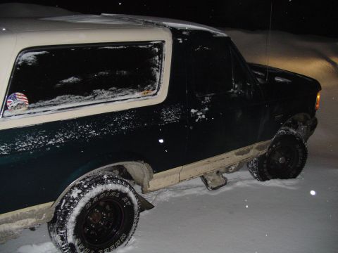 1993 Ford Bronco - A Ford Bronco is seen in a snowy environment at night.