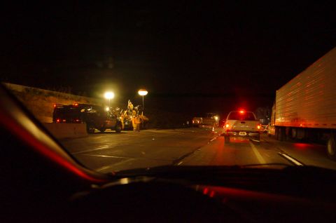 2003 Ford Taurus - A nighttime scene shows an accident with emergency personnel and vehicles on the highway.