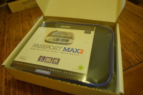 2003 Ford Taurus - A radar detector is shown inside its packaging, with the product name clearly visible.