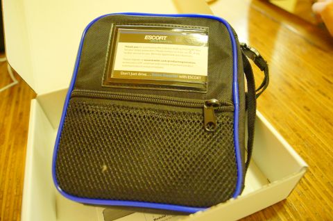 2003 Ford Taurus - A black and blue carrying case, likely for a radar detector, sits in its packaging. The case features a mesh pocket and a clear window with…