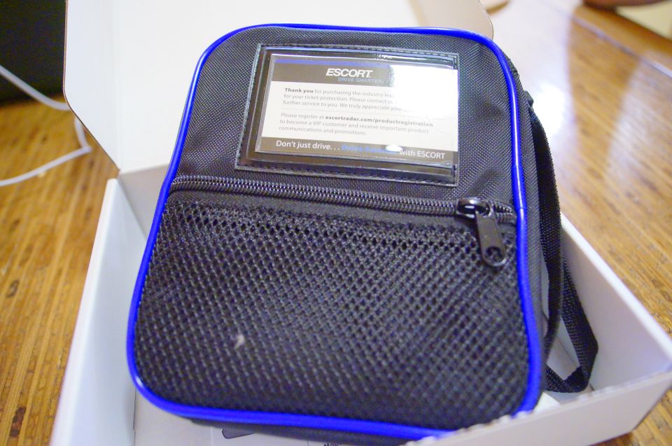 Escort radar detector carrying case with blue trim and a mesh pocket