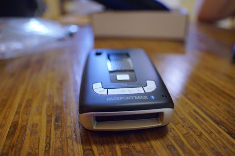 2003 Ford Taurus - The Escort Passport Max radar detector is shown on a wooden surface.