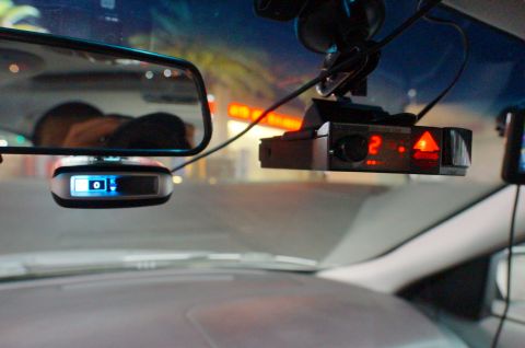 2003 Ford Taurus - Interior view of a vehicle's windshield showing mounted electronic devices.