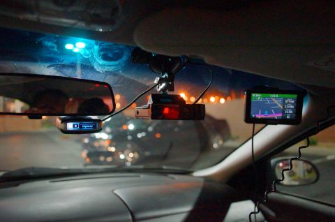 2003 Ford Taurus - Interior view of a car's dashboard equipped with a radar detector and GPS navigation system.