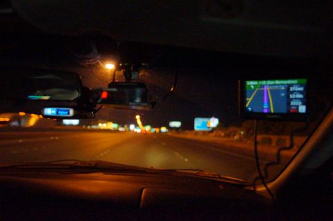 2003 Ford Taurus - Driving at night with GPS and radar detector visible on the dashboard.
