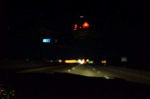 2003 Ford Taurus - View from inside a car at night, showing dashboard lights and the road ahead.