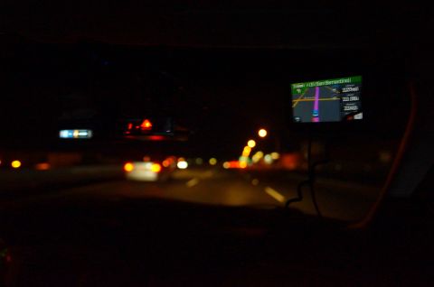 2003 Ford Taurus - View from inside a vehicle at night, with a GPS screen displaying navigation.