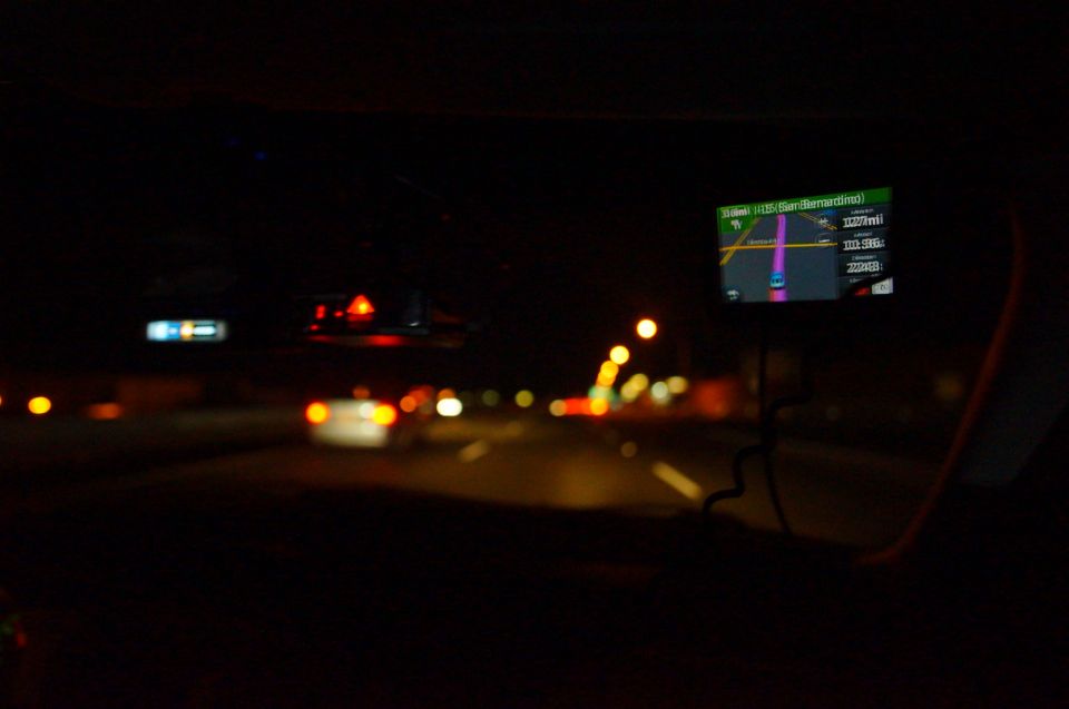 Dashboard GPS screen showing route to San Bernardino at night