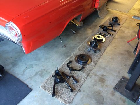 1964 Ford Fairlane - Disassembled front suspension parts are laid out next to the red 1964 Ford Fairlane body.